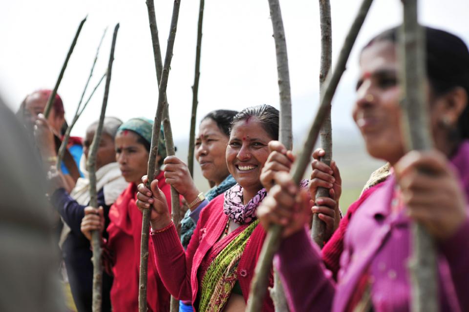 Women holding wood sticks