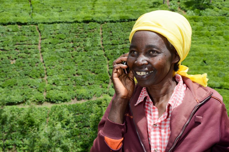 Farmer Rachael Njeri on the phone in Kenya