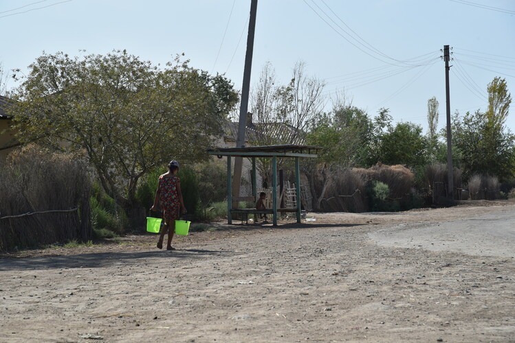 Girl is carrying drinking water home, as water scarcity is one of the major problems in Karakalpakstan