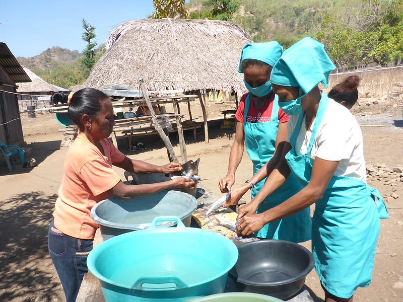 WorldFish-supported women’s group in Beacou village preparing sardines. Photo: WorldFish