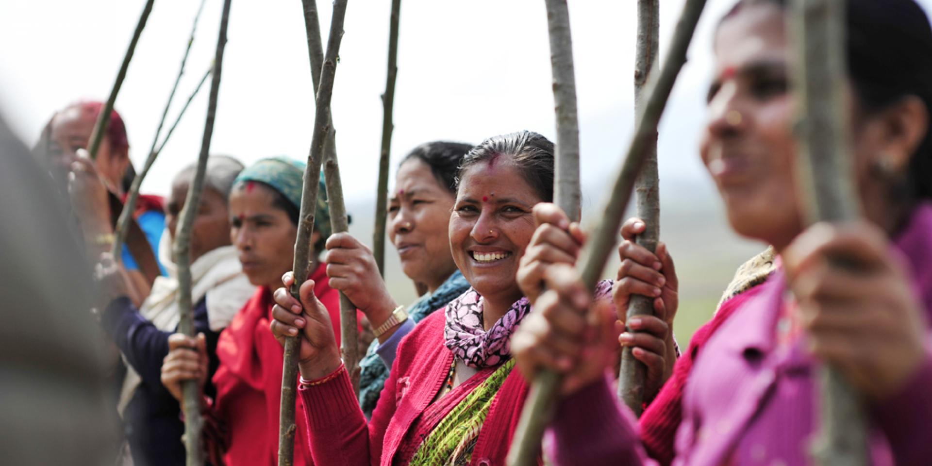 Women holding wood sticks