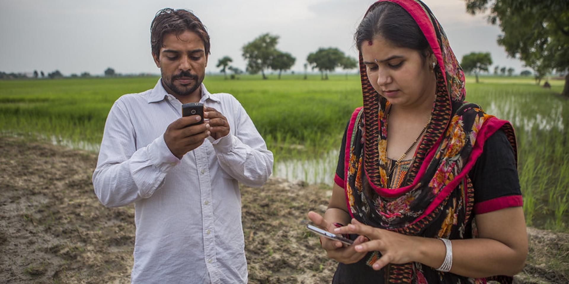 Husband and wife in India receive regular updates on weather and climate-smart practices via their mobile phones. Photo by Prashanth Vishwanathan/CCAFS.