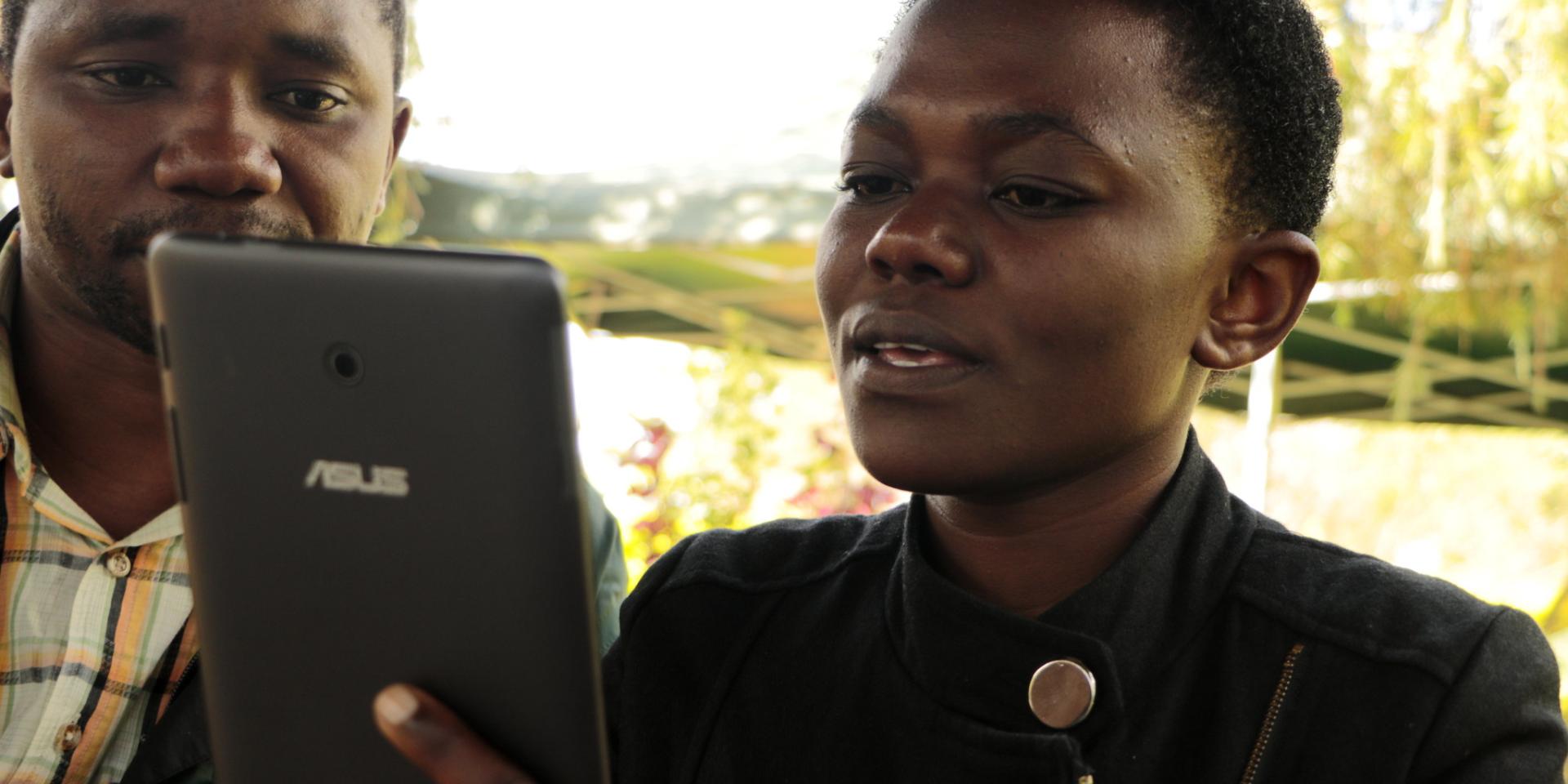 Researcher collecting data into her tablet