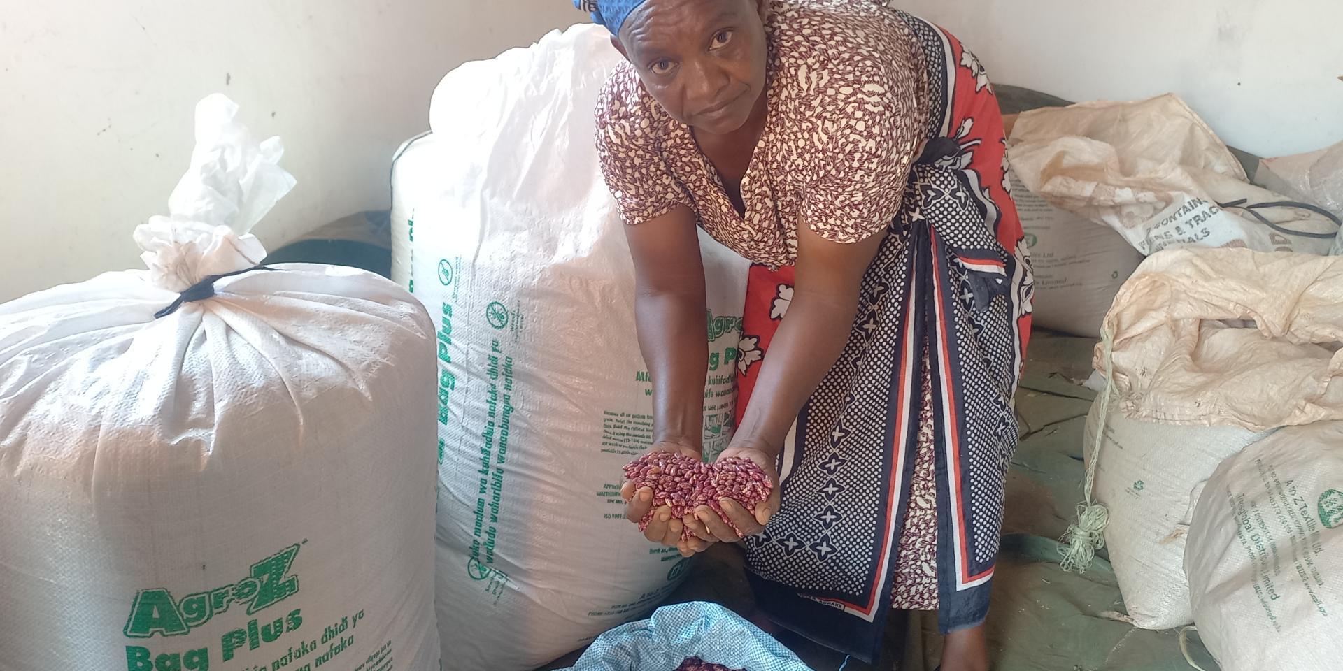 Eleanor Muli, of Makindu Ward, with her Nyota beans stored in hermitic bags