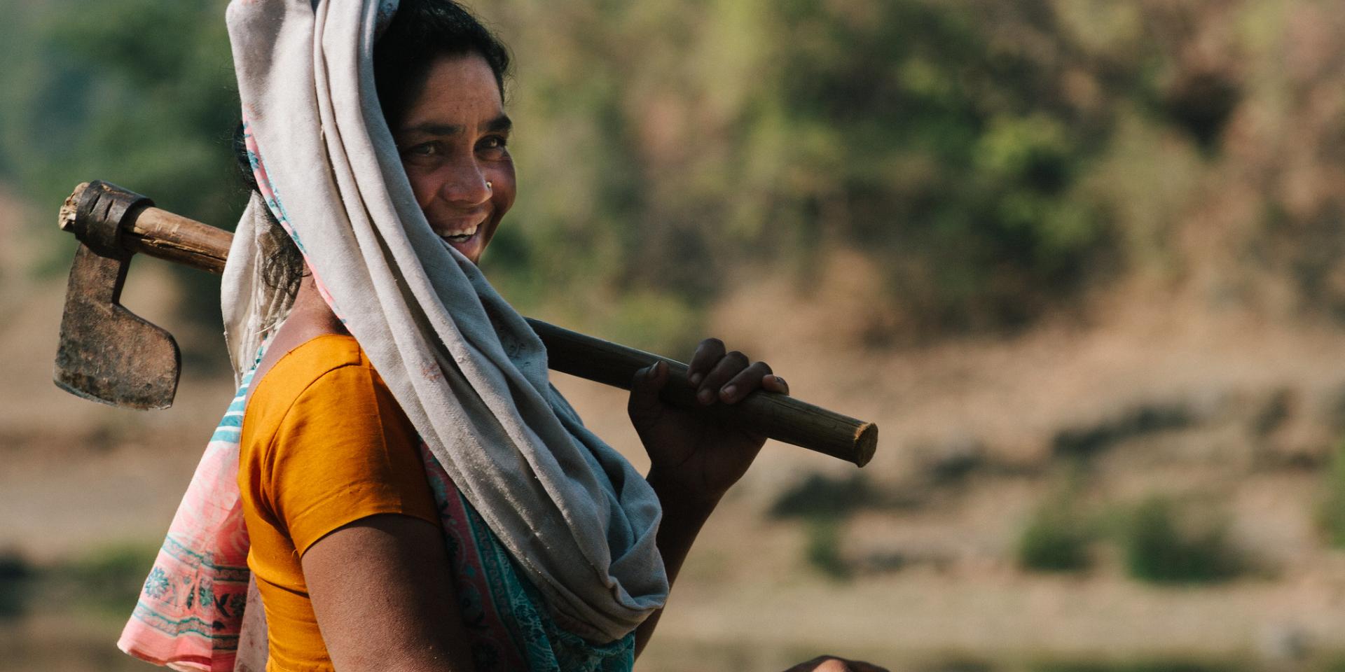 Woman carrying hoe