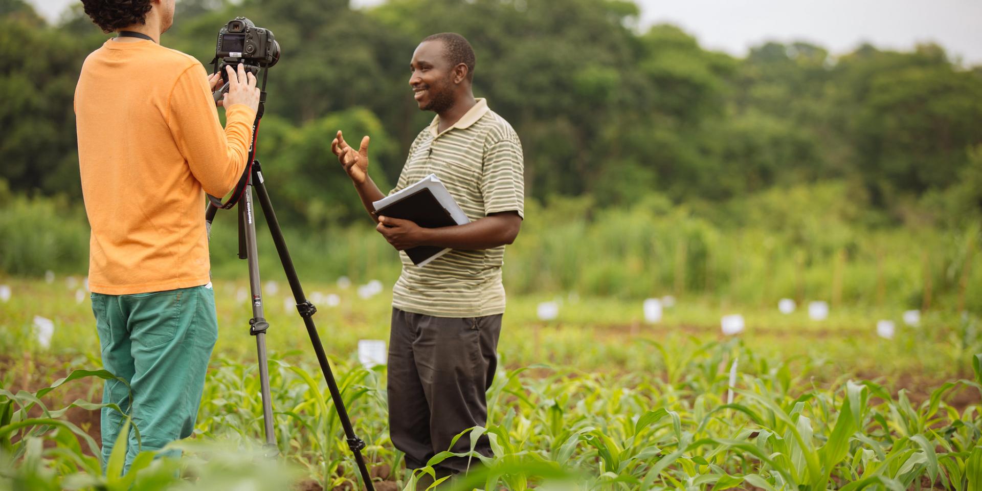 IFPRI Videographer Milo Mitchell records a video interview in an experimental maize field with a Trans-SEC researcher in Kilosa, Tanzania.