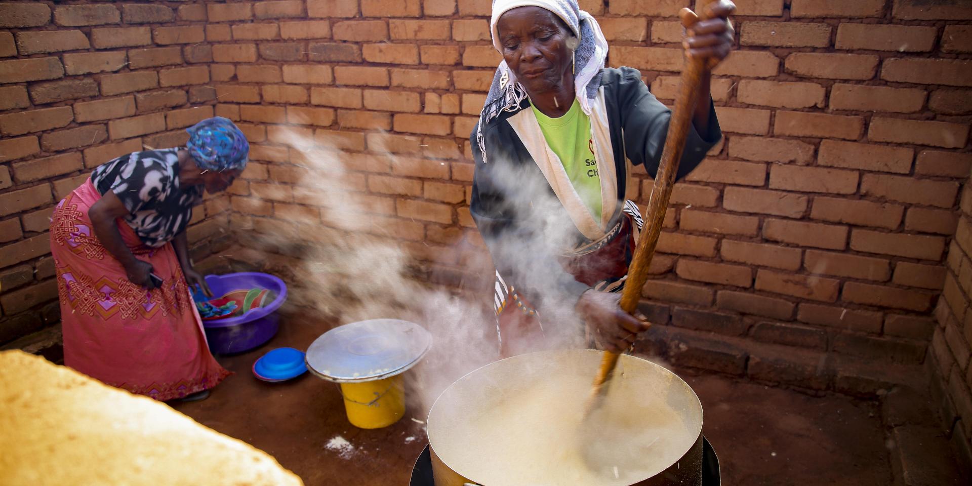 Women preparing food at a child care center in Malawi