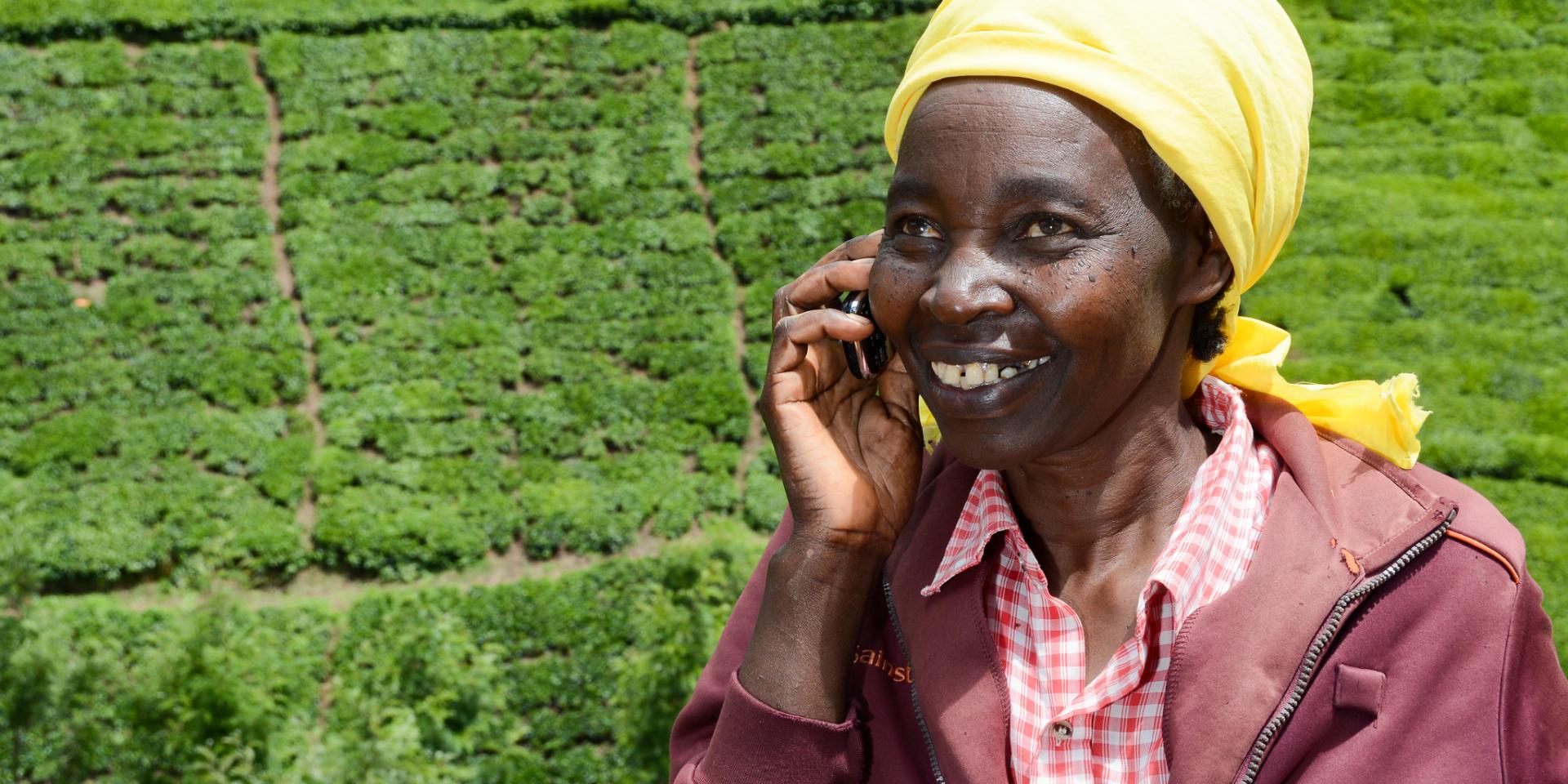 Farmer Rachael Njeri on the phone in Kenya