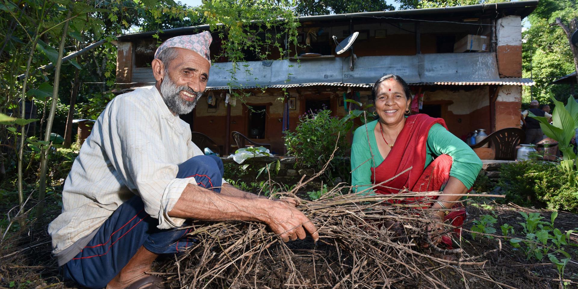 Man and woman composting at a farm near Rupa Lake, Nepal. 