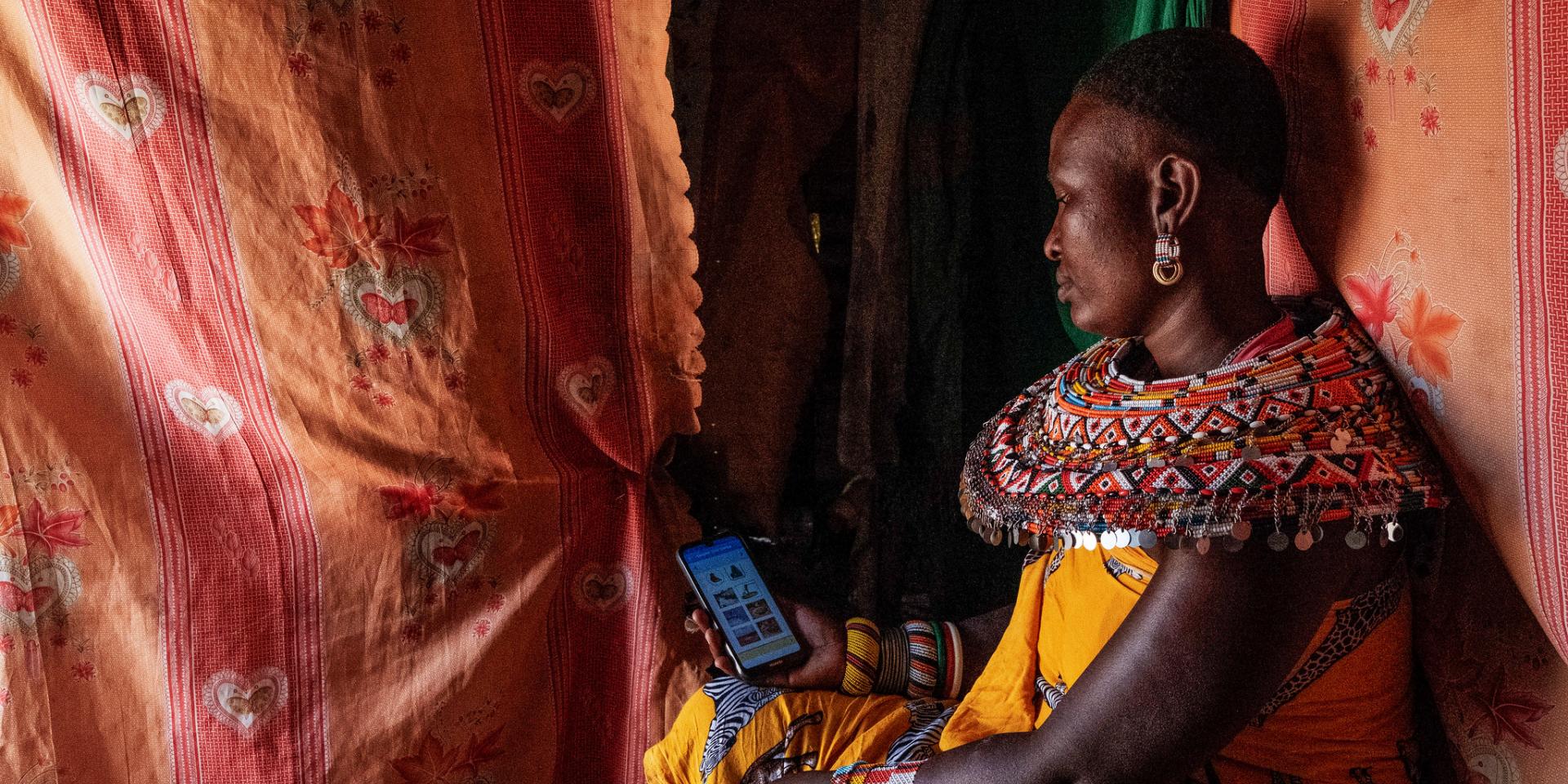 A Samburu mother enters nutrition data into an app
