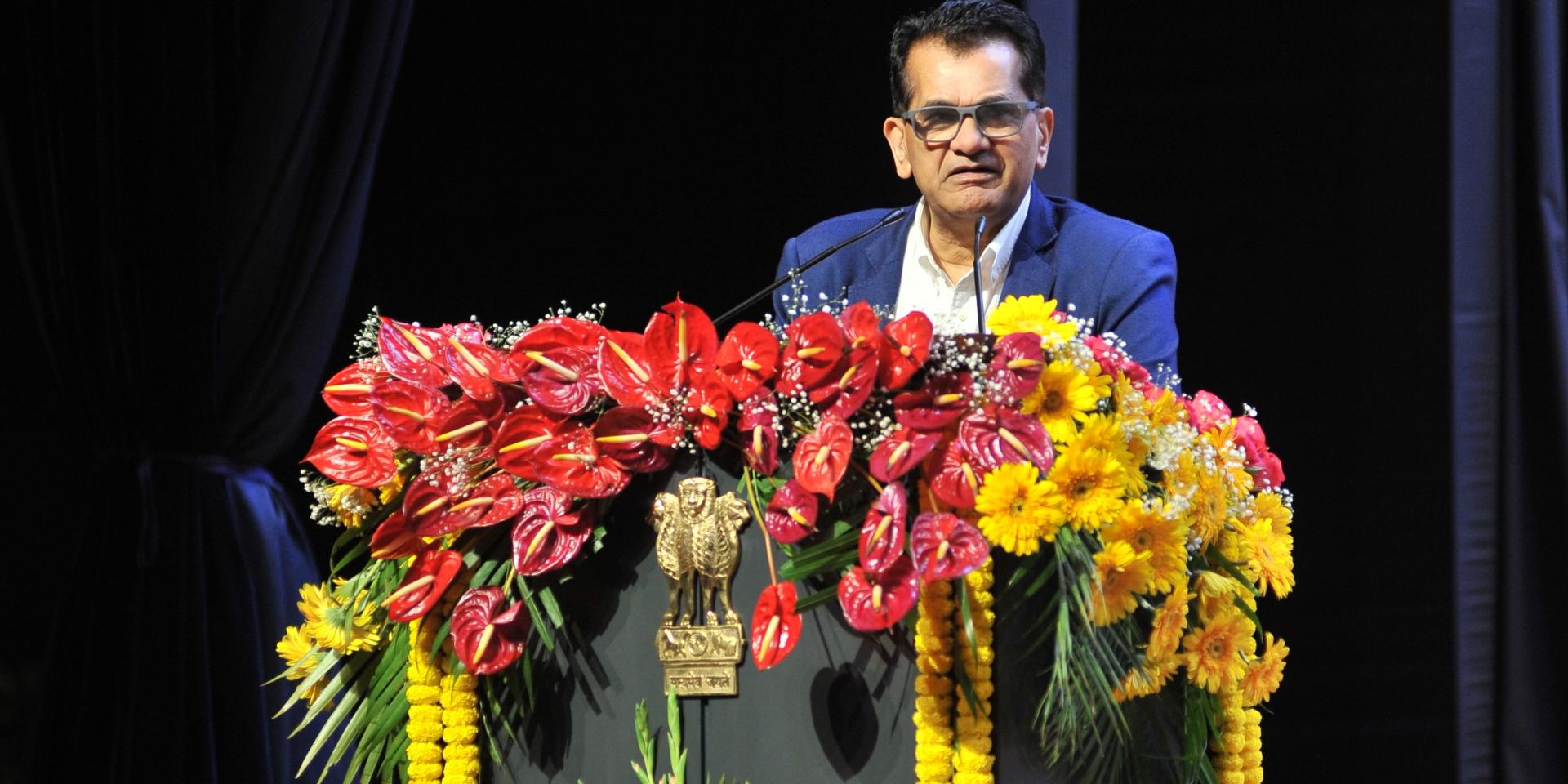 Amitabh Kant standing at lectern