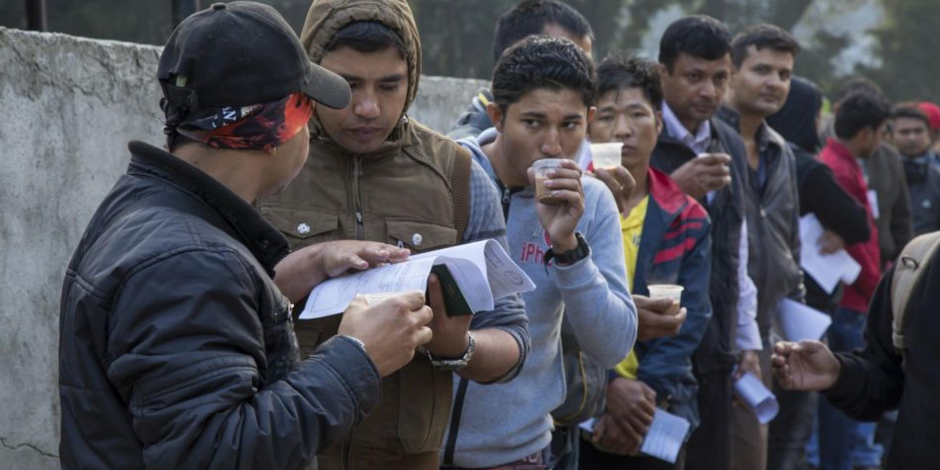 Migrant workers at Kathmandu with their documents.