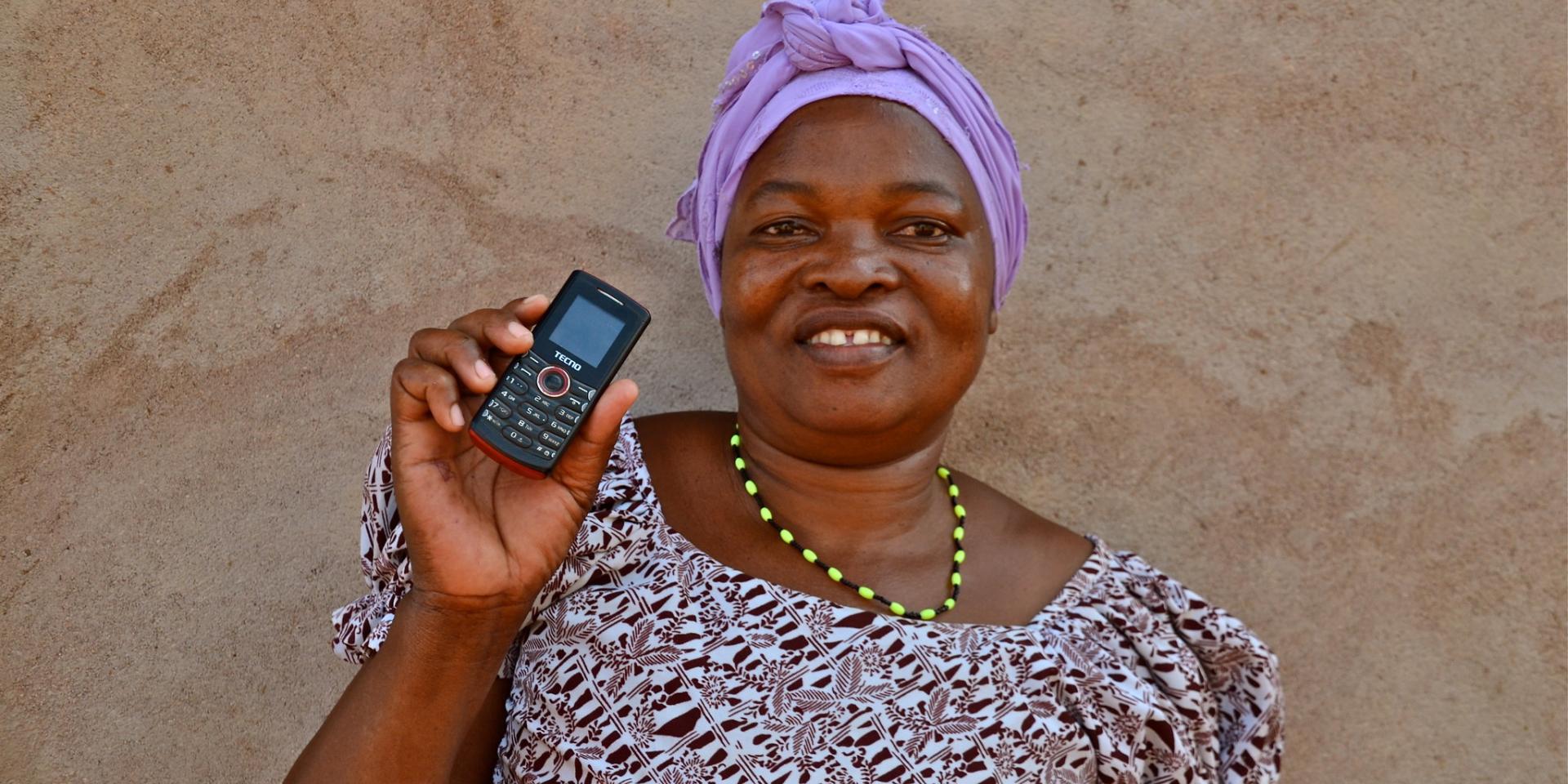 Woman farmer with phone in Tanzania