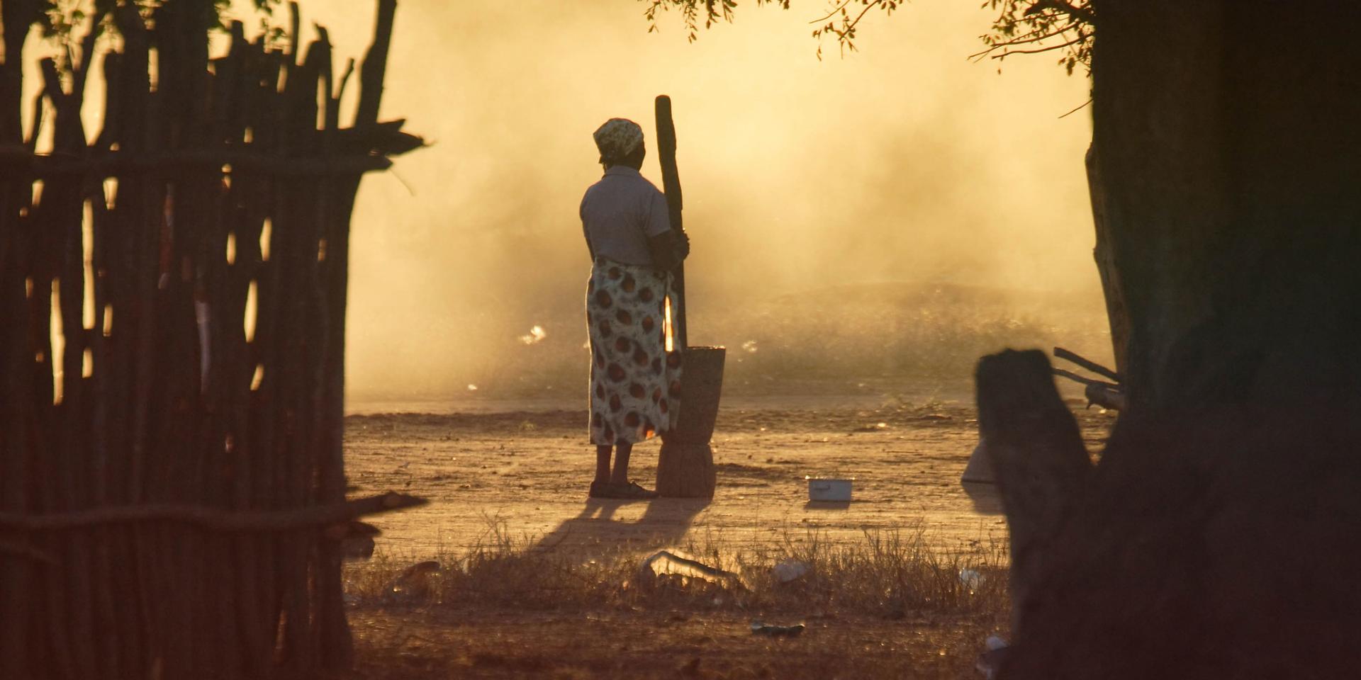 Woman pounding maize in Mozambique