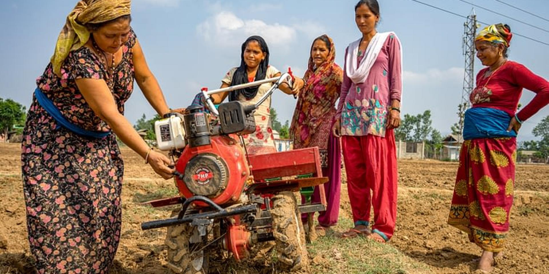 Women farmers with a mini tiller