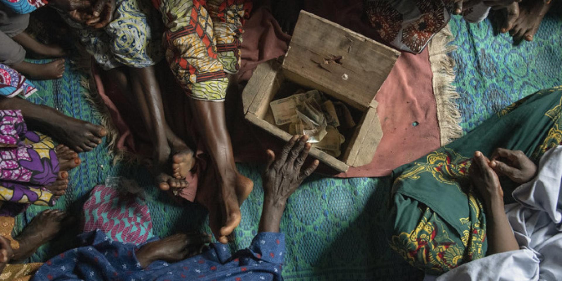 Each month members of a women’s group in Nigeria come together to discuss and share their earnings. Their money is gathered in a communal savings box and deposited in the bank, where they can earn interest. From their savings they help each other and the community. Photo by C. de Bode/CGIAR.