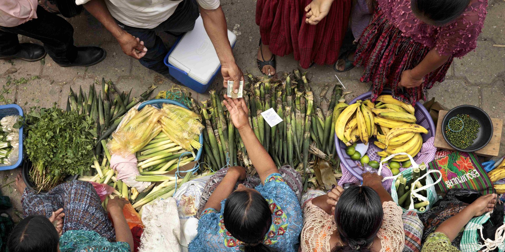 Indigenous women buying and selling produce in Guatemala