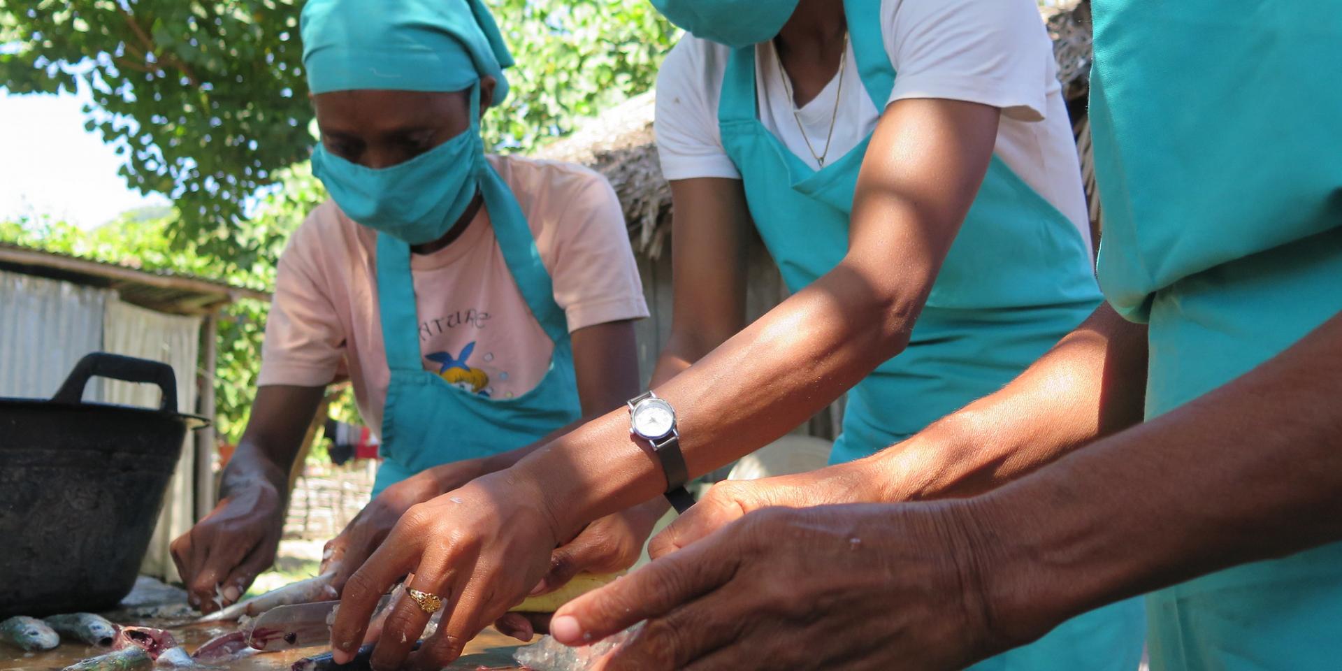 Women packing sardines in Timor-Leste.