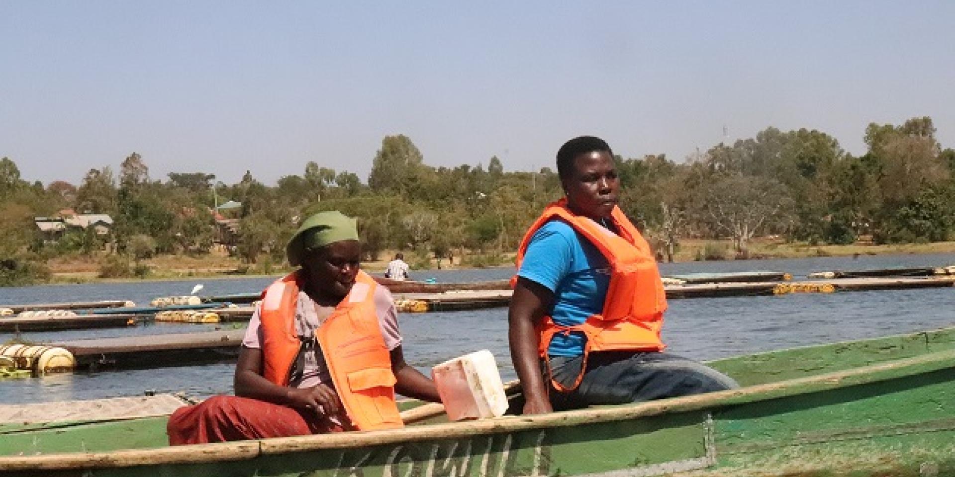 Women feeding fish in the cages in Lake at Dunga Beach, Kisumu County