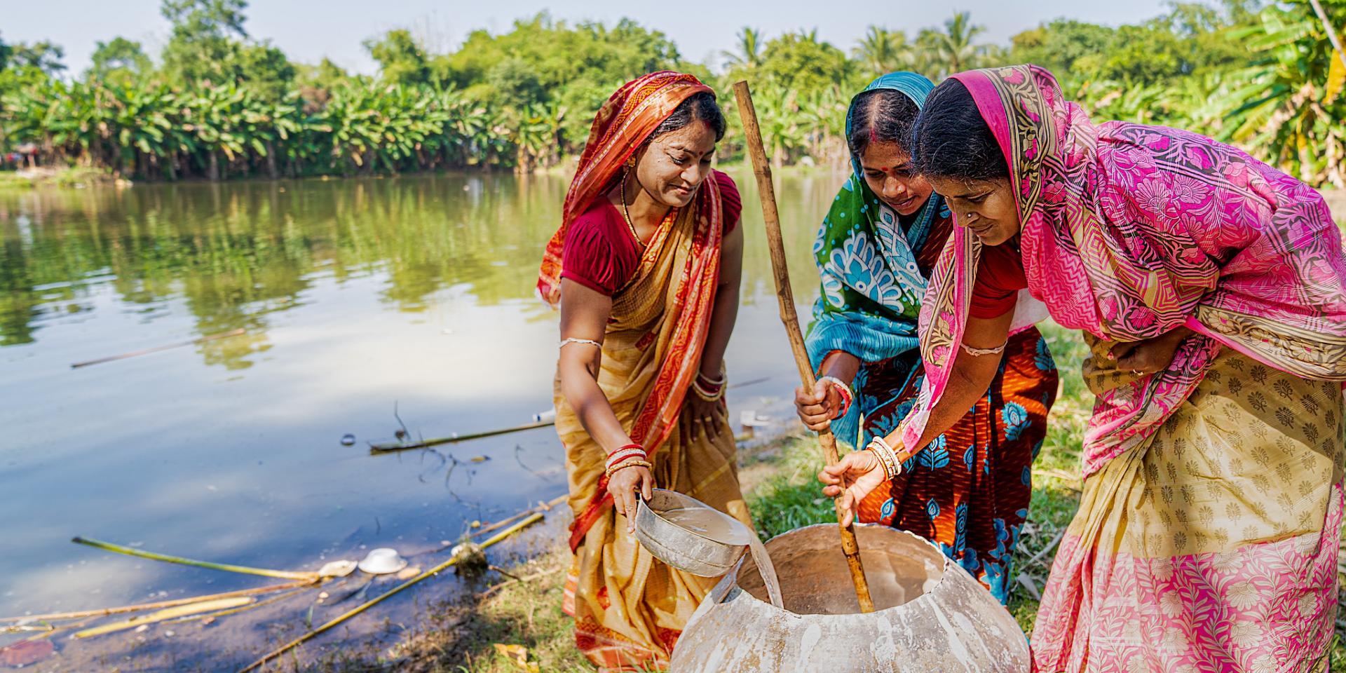 Indian women pouring water