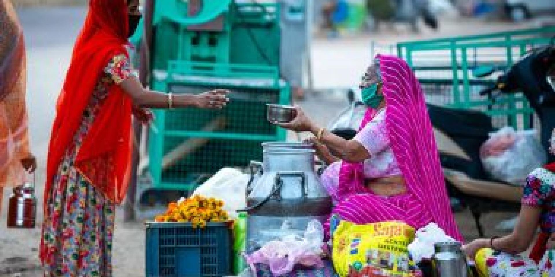 A woman buying food from a vendor