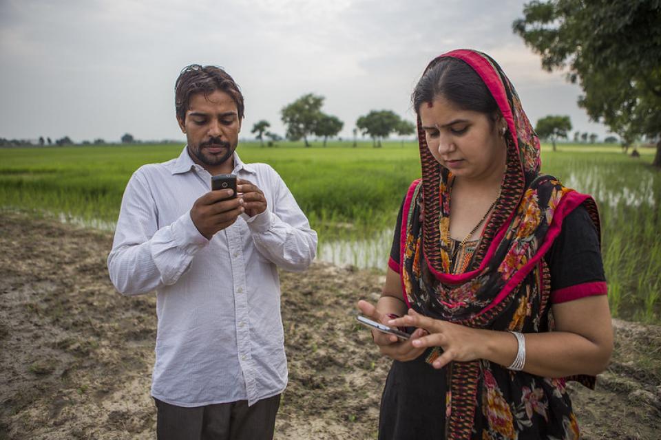 Husband and wife in India receive regular updates on weather and climate-smart practices via their mobile phones. Photo by Prashanth Vishwanathan/CCAFS.