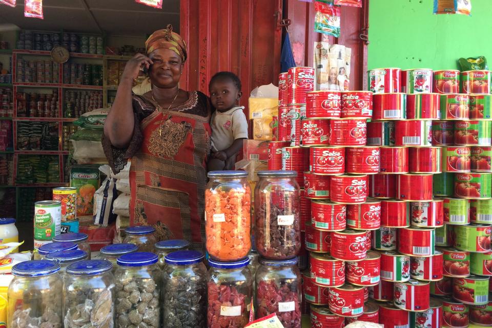 Woman on the phone in a store in Ghana