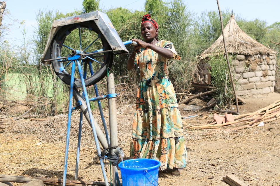 Woman fetching water from a borehole