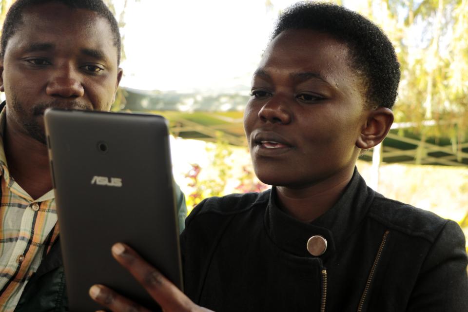 Researcher collecting data into her tablet