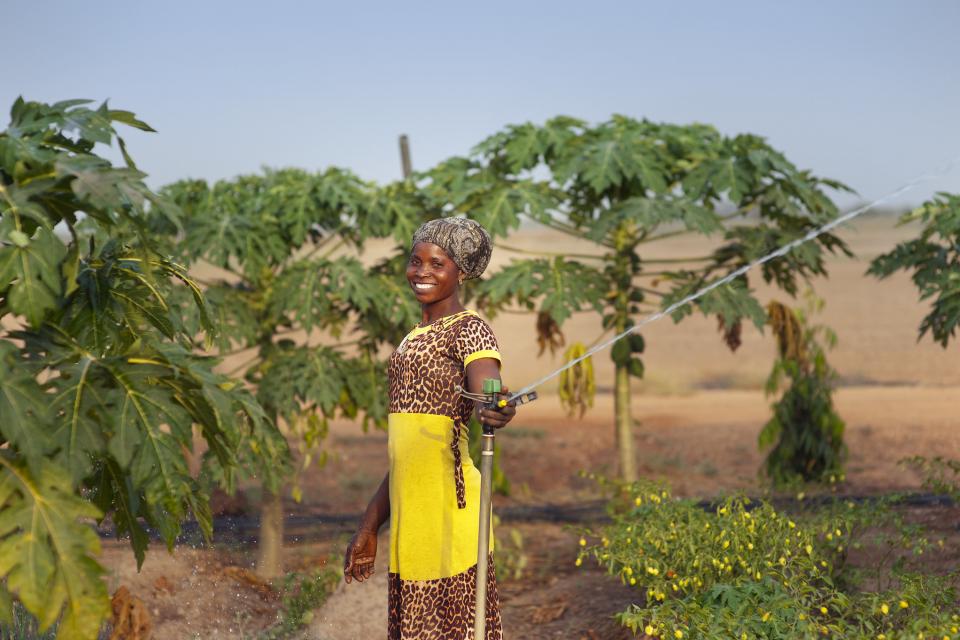 A woman using a sprinkler