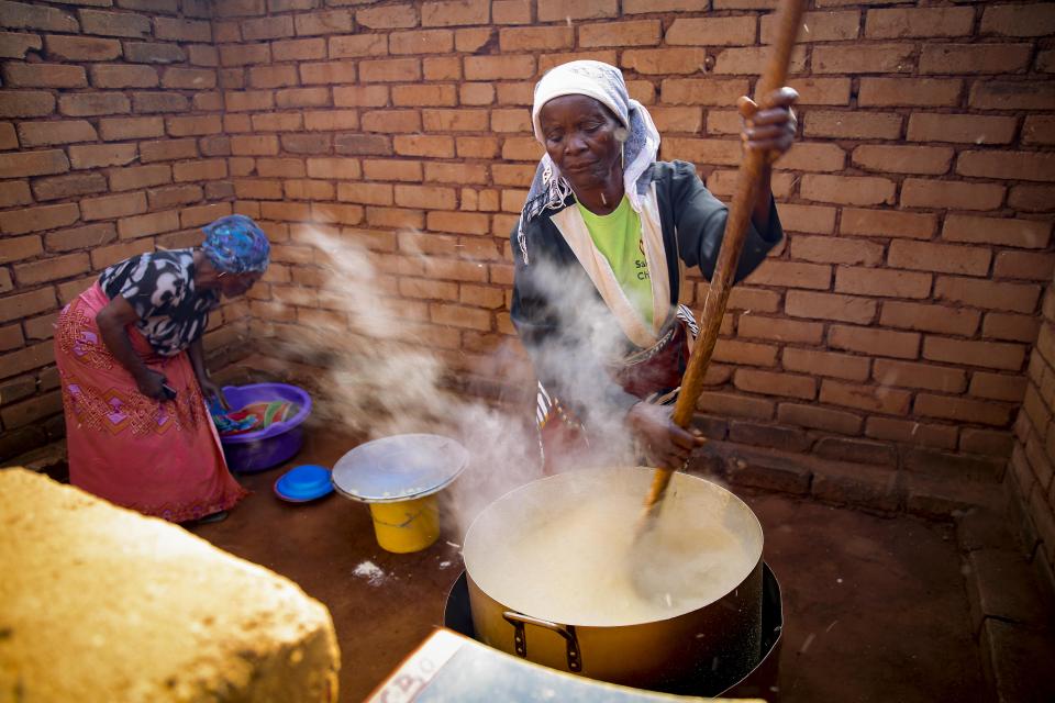 Women preparing food at a child care center in Malawi