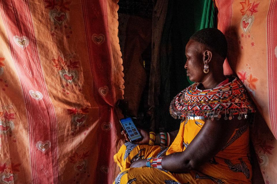 A Samburu mother enters nutrition data into an app