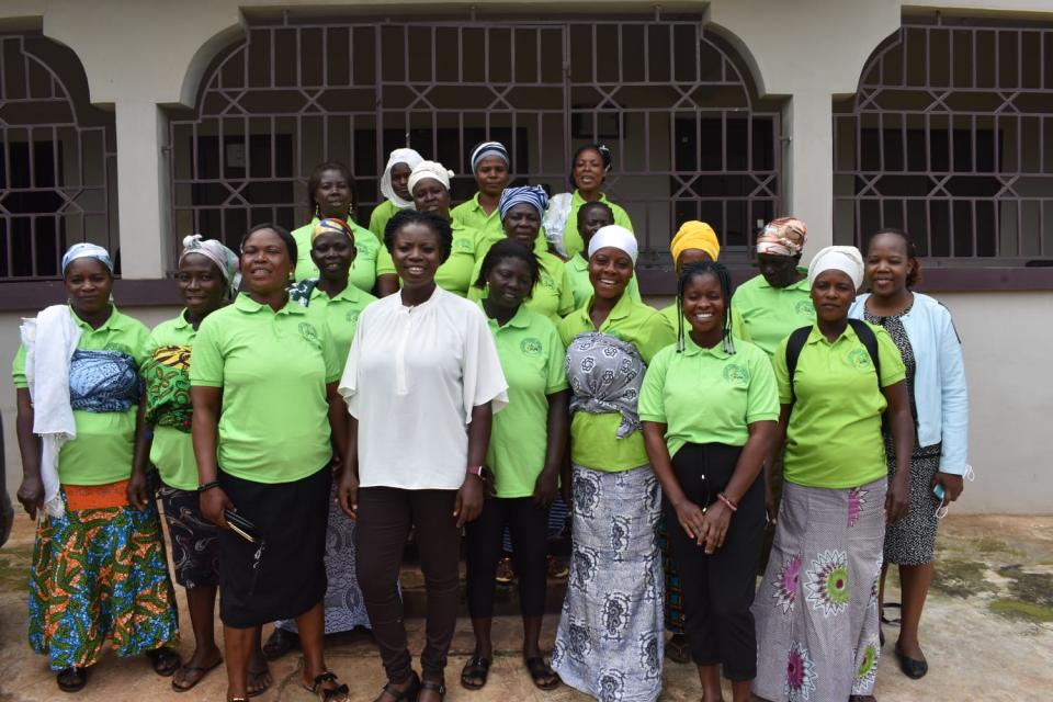 Edith Akosah Wheatland poses for a picture with farmers at Ankomado