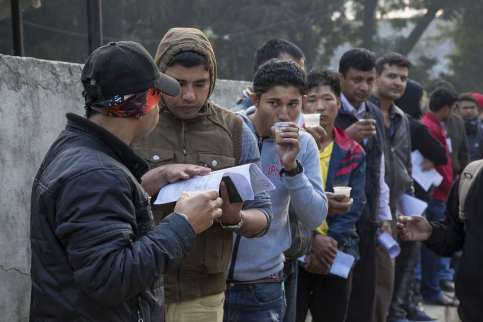 Migrant workers at Kathmandu with their documents.