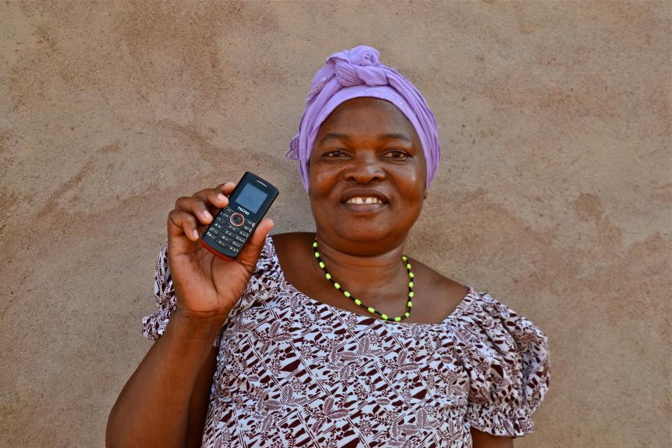 Woman farmer with phone in Tanzania