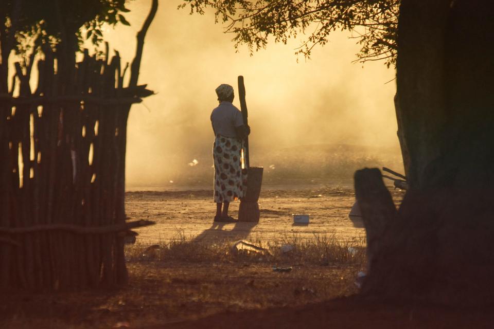 Woman pounding maize in Mozambique