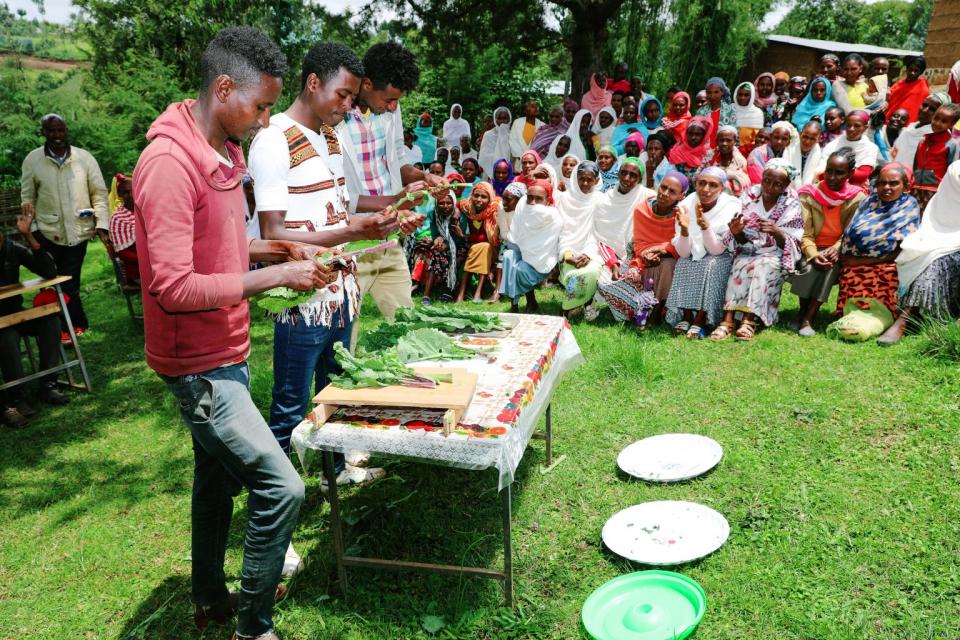 Men peeling vegetables