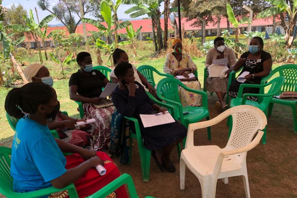 Farmers sitting on chairs during survey.