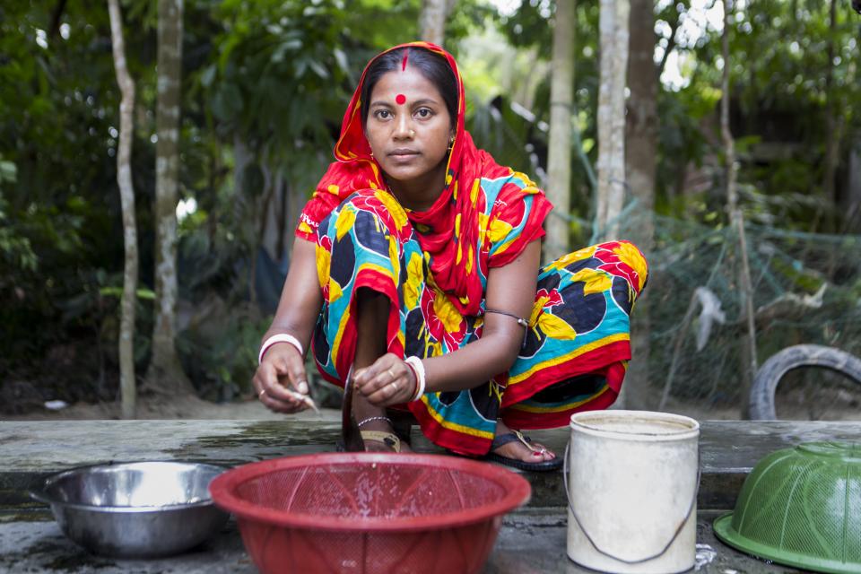 Woman preparing mola in Bangladesh.