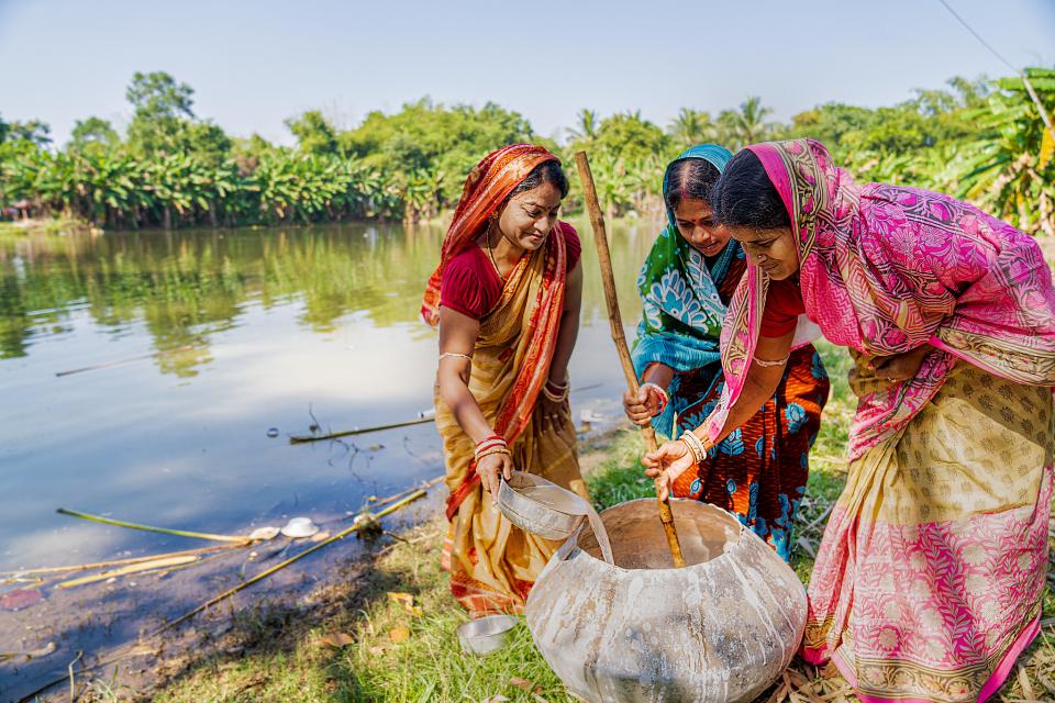 Indian women pouring water