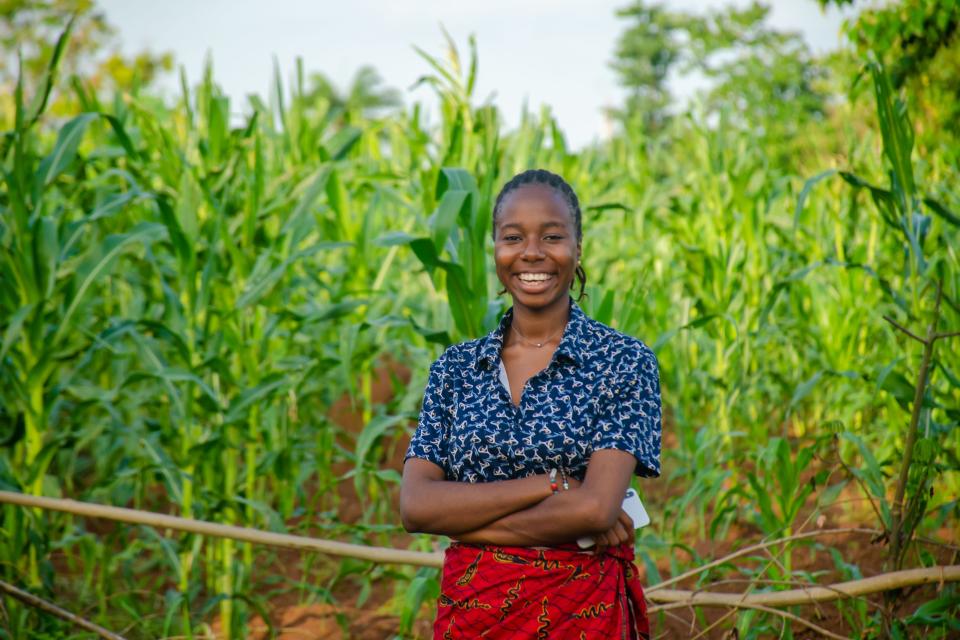 happy woman farmer in maize plantation